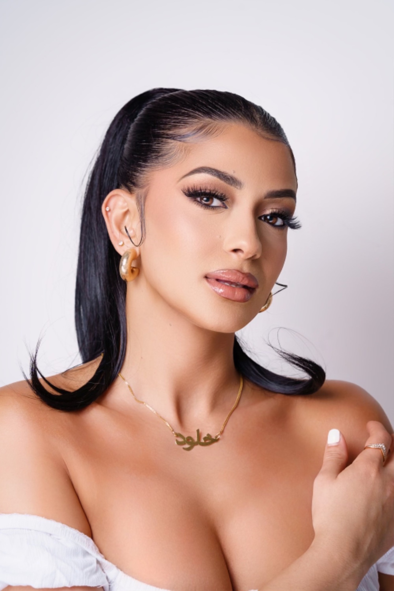 Bride with sleek styled hair and soft glam finish
